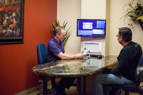 Doctor and patient sitting at office desk viewing teeth imagery at Robert F. Walker Jr. DDS in Chandler, AZ 