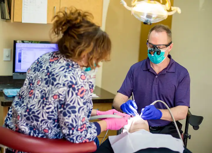 Dr. Walker and team member treating patient at Robert F. Walker Jr. DDS in Chandler, AZ 