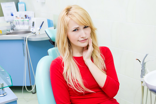 Woman holding jaw before appointment at Robert F. Walker Jr. DDS in Chandler, AZ